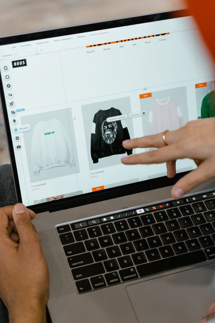 gallery-04 Close-up view of hands using a laptop indoors to browse a shopping website on the screen.